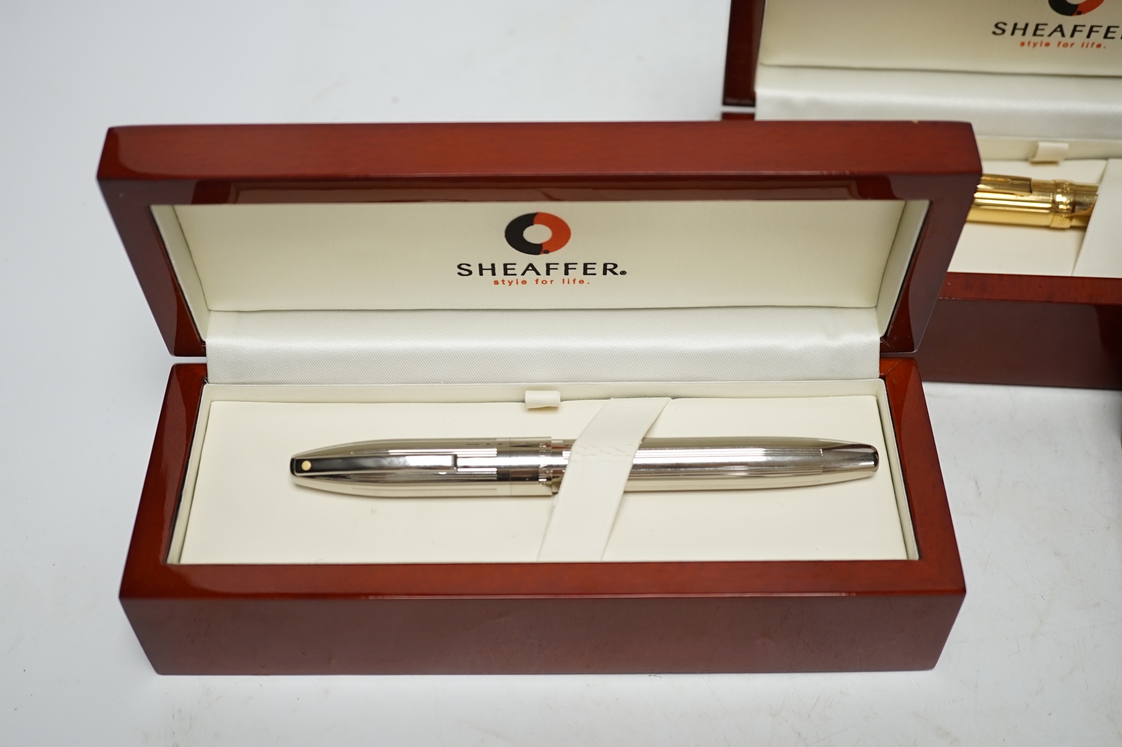 Three modern boxed Sheaffer fountain pens; an Imperial style pen and two others, all in stained beech cases